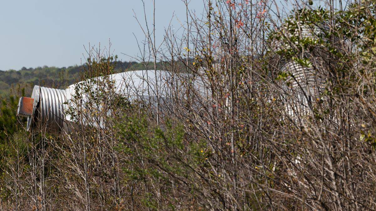 Busted Plug, a sculpture by Columbia artist Blue Sky, lies in a field north of Columbia on Wednesday, March 26, 2025. The 40-foot sculpture was installed in downtown Columbia until 2023.