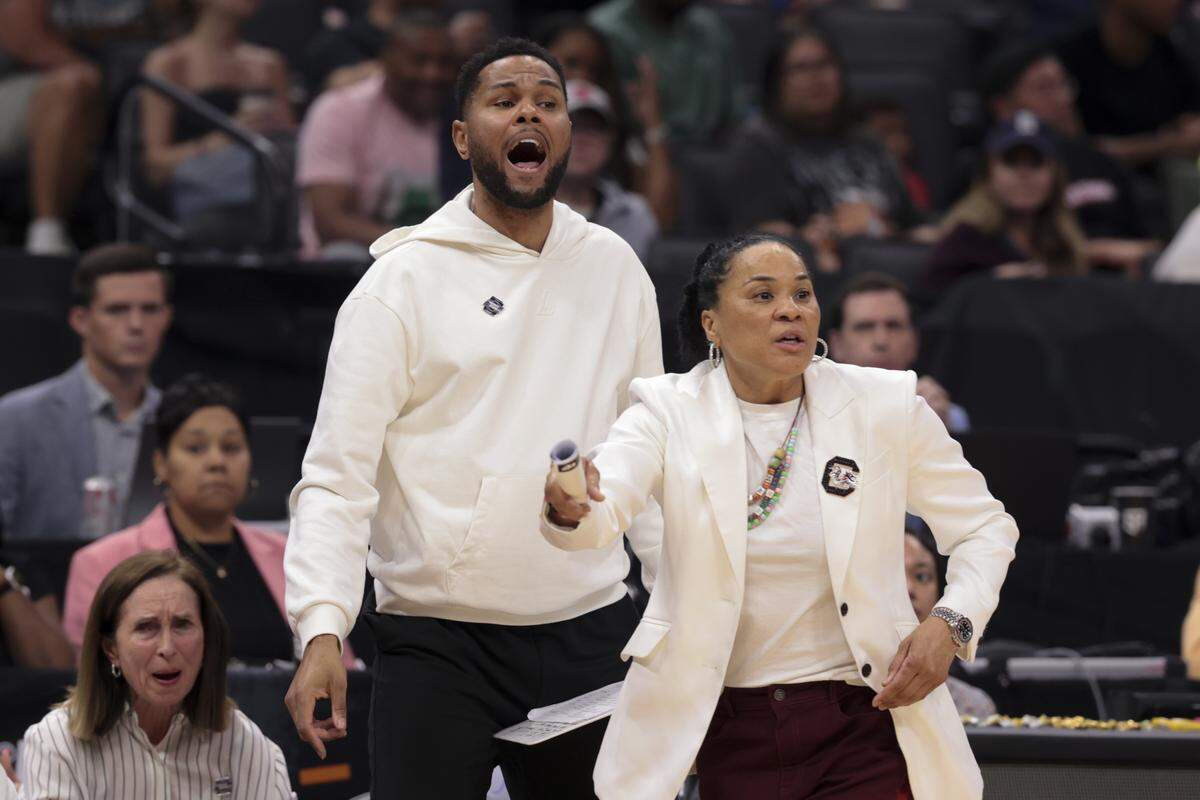 South Carolina's head coach Dawn Staley and assistant coach Wendale Farrow talk to their team during the second half of action of their Elite Eight women's basketball game against TCU at Golden 1 Arena on Monday, March 30, 2026.
