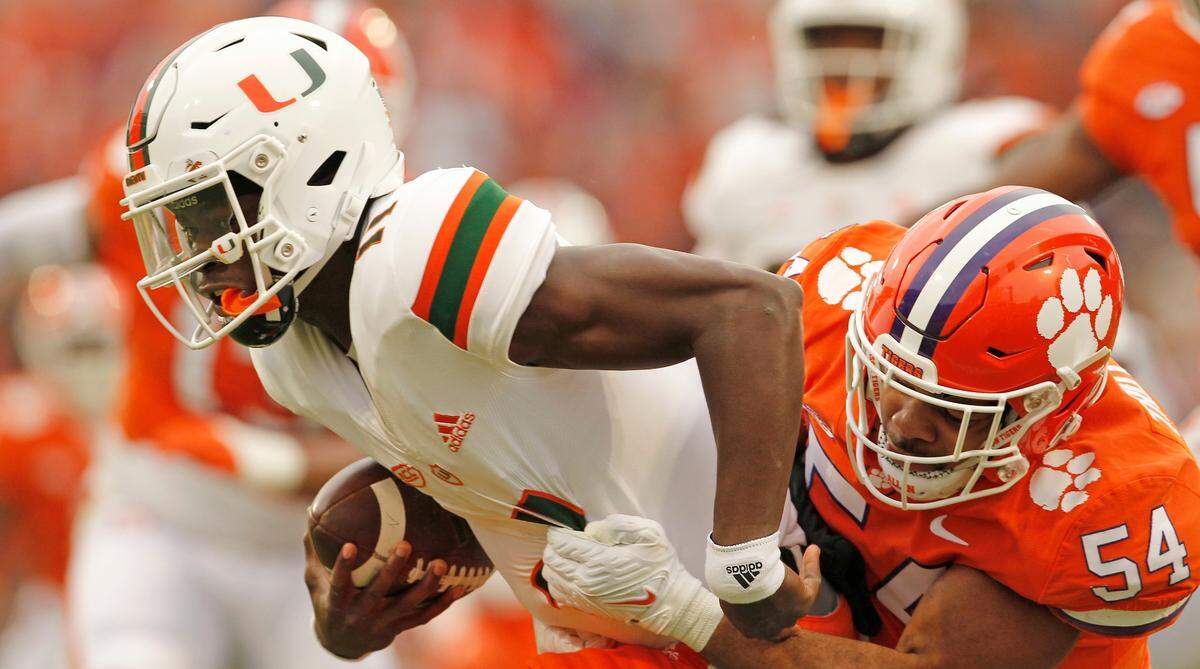 Clemson linebacker Jeremiah Trotter Jr. (54) sacks Miami quarterback Jacurri Brown (11) during first-quarter action in Clemson, S.C. on Saturday, Nov. 19, 2022.