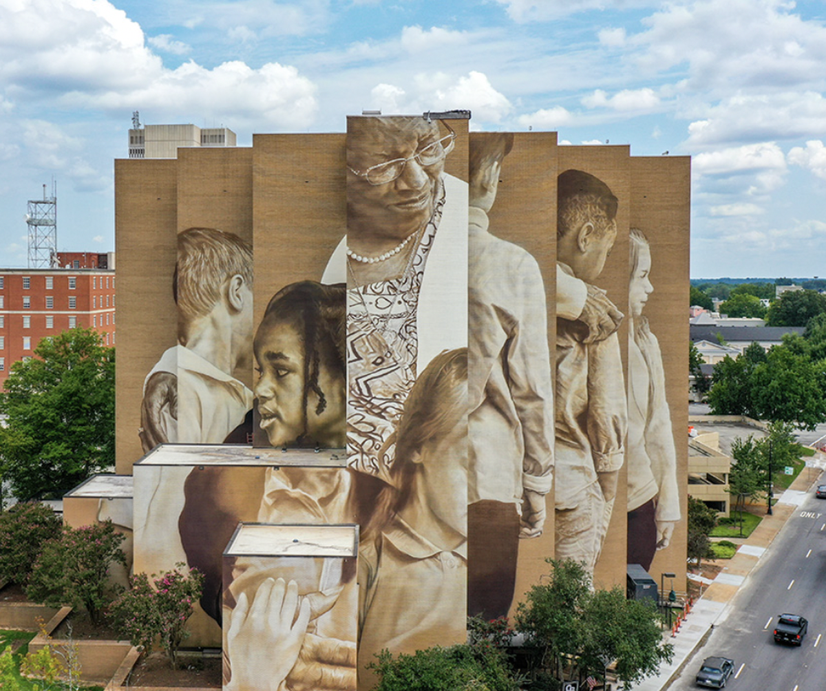 A mural on the side of an eight-story building at one entrance the downtown Greenville honors Pearlie Harris, a pioneer in education.