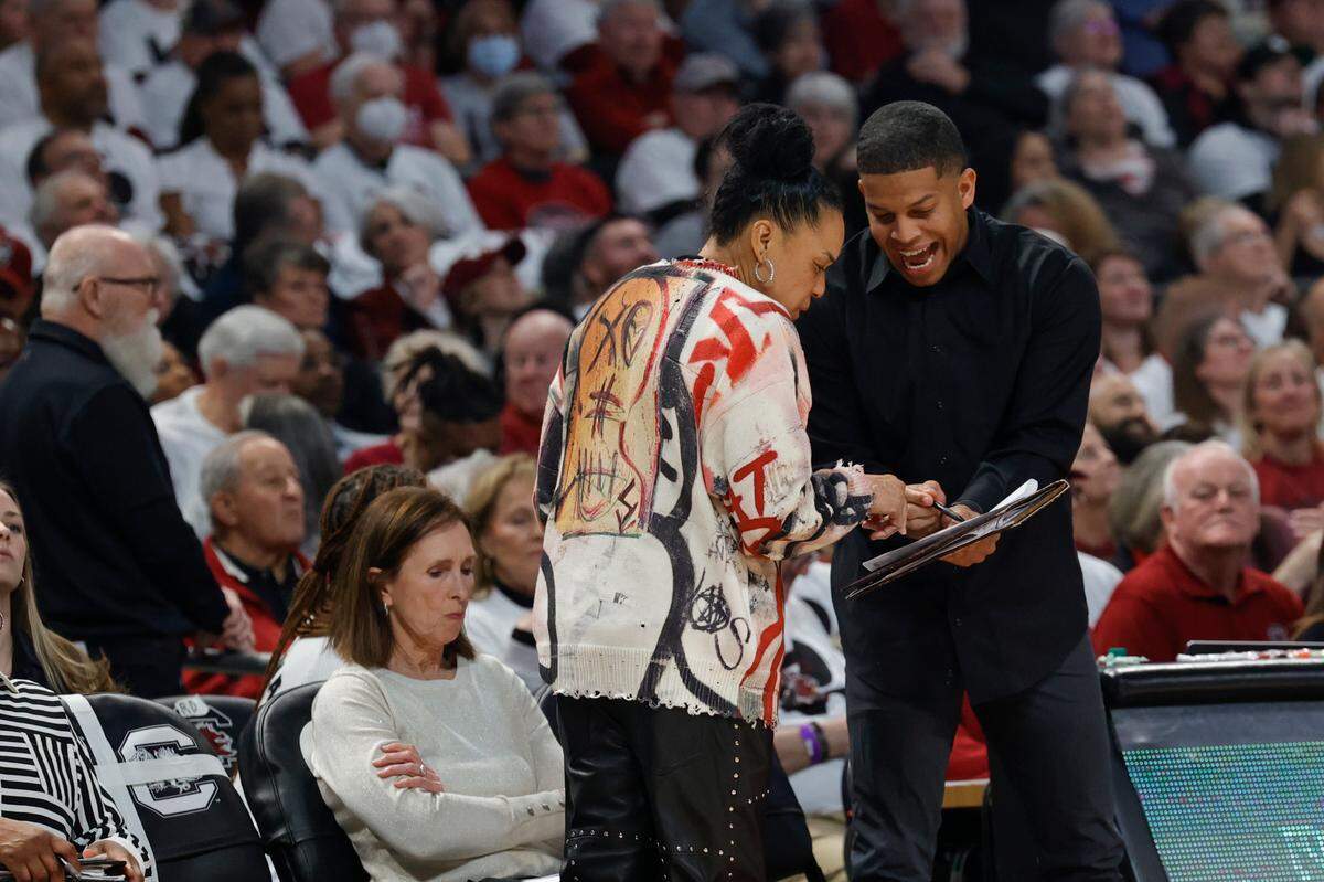University of South Carolina Head Coach Dawn Staley talks with University of South Carolina Assistant Coach Winston Gandy during the first half of action in the Colonial Life Arena on Sunday, Feb. 11, 2024