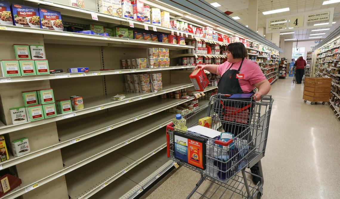 Michelle Merritt, 15, collects items for a customer at The Piggly Wiggly on Devine Street. The store offers both curbside pickup and a grocery delivery service that have been extremely busy in recent weeks. 3/24/20