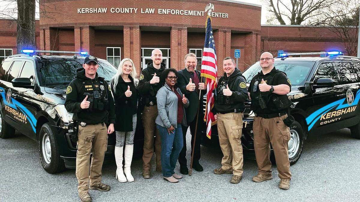 Pro wrestling great “Hacksaw” Jim Duggan, third from right, and his wife Debra Duggan, second from left, are pictured with members of the Kershaw County Sheriff’s Office. That includes, from left, Master Deputy Harrison Wells, Cpl. John Patton, Brenda Johnson, Lt. Ben Royalty, and Deputy Joshua Chavis.