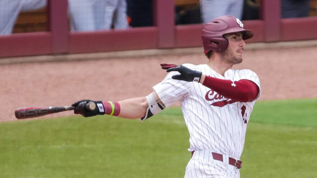South Carolina Gamecocks first baseman Josiah Sightler (12) hits a two-run single to tie the game 3-3 in the 6th inning against the Virginia Cavaliers.
