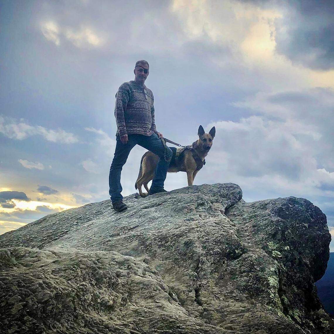 Parrish Phillips, pictured with his service dog Max, was shot and killed.