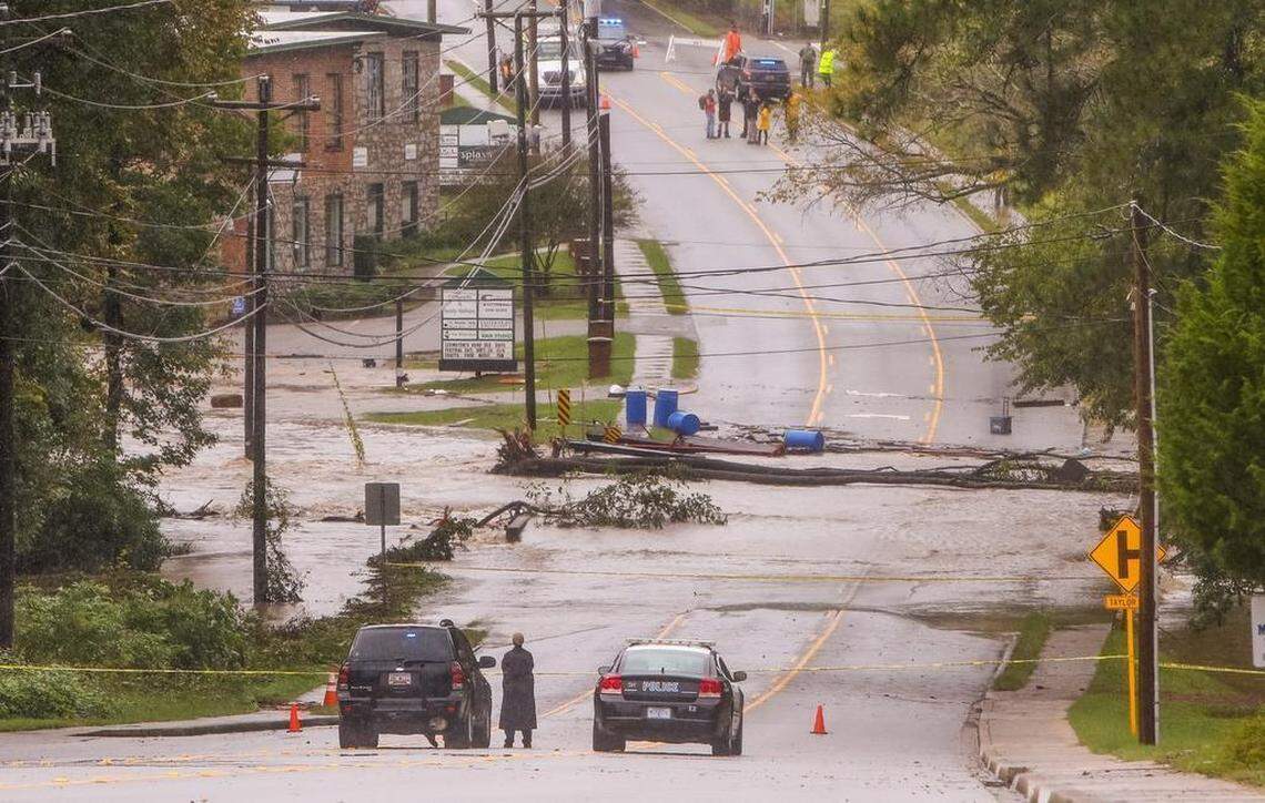 A portion of Main street in Lexington was closed off after flood waters in Twelvemile Creek broke through the Old Mill dam in Lexington on Oct. 4, 2015.