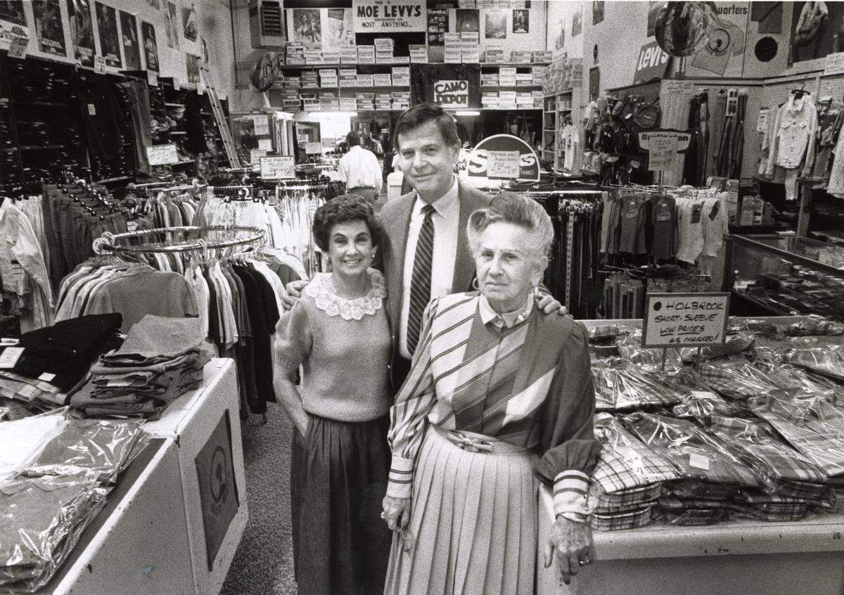 Gloria Rittenberg, her husband Harold Rittenberg, and Florence Levy stand amid jeans and tops stacked in their Moe Levy’s Assembly Street store. 1987