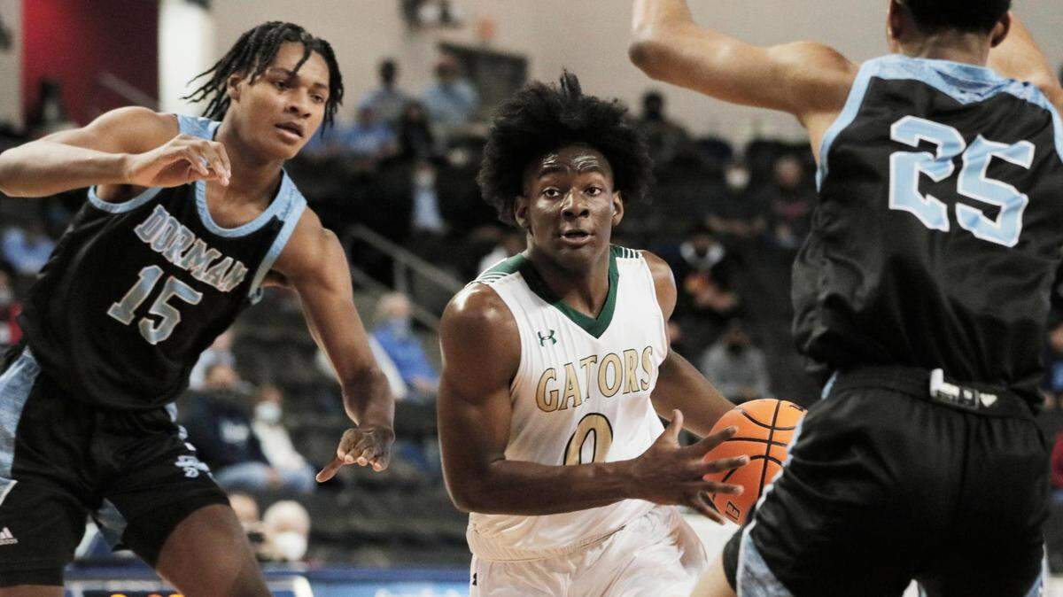 River Bluff’s Myles Jenkins (0) is guarded by Dorman’s Noah Clowney (15) and Earl Burgess (25) in Aiken, South Carolina on Saturday, March 6, 2021.