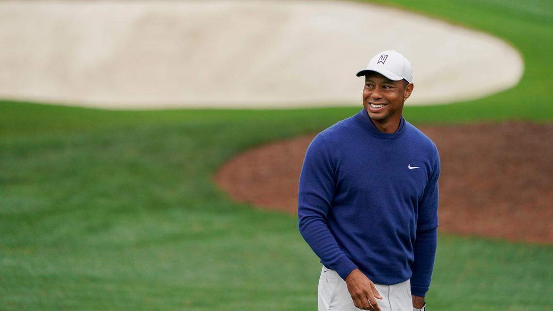 Tiger Woods warms up on the practice range during Monday’s practice round for The Masters golf tournament at Augusta National Golf Club.