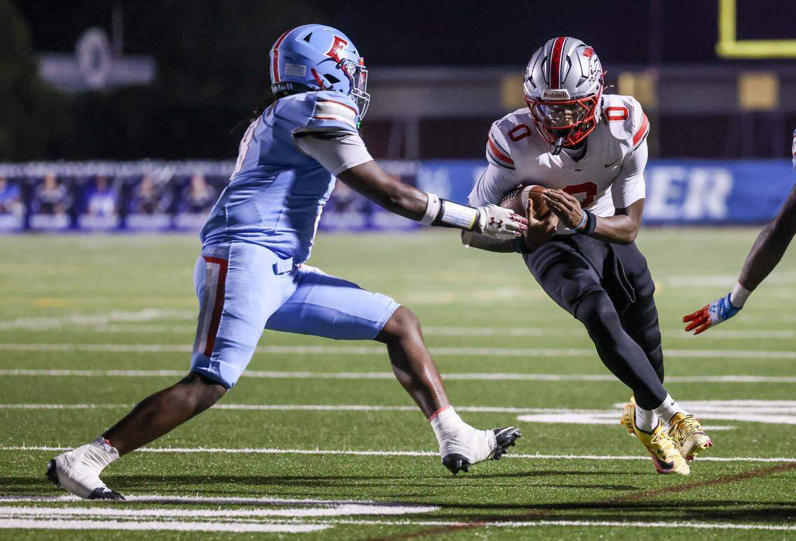 J'Zavien Currence (0) of South Pointe is driven out of bounds by Jordan Davis (8) of AC Flora during AC Flora’s game against South Pointe at Memorial Stadium on Sept. 19, 2025.