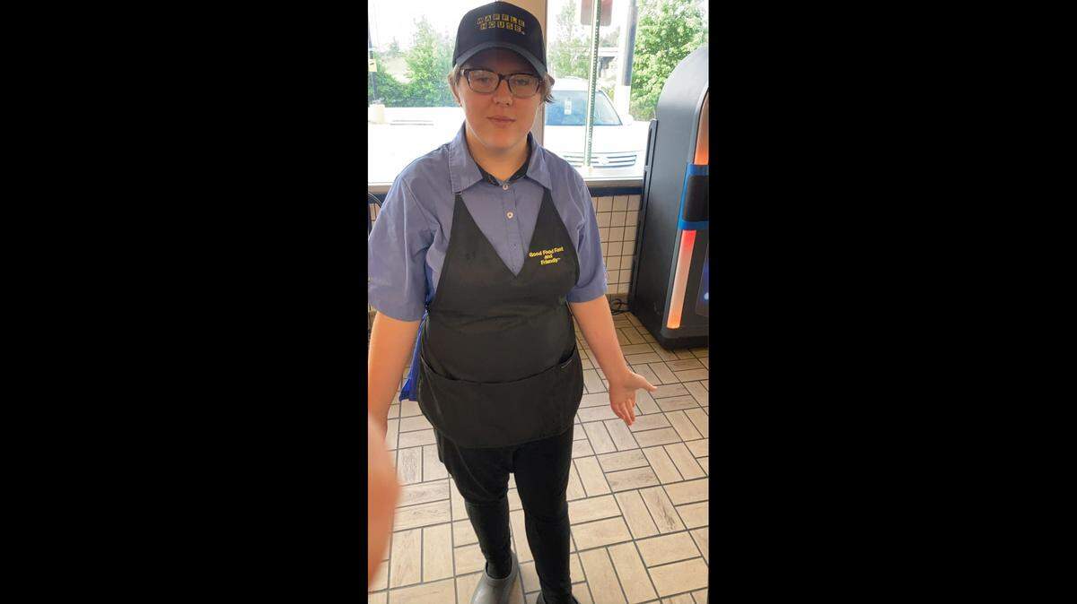 Jacob Williamson posing for a picture in his Waffle House uniform.