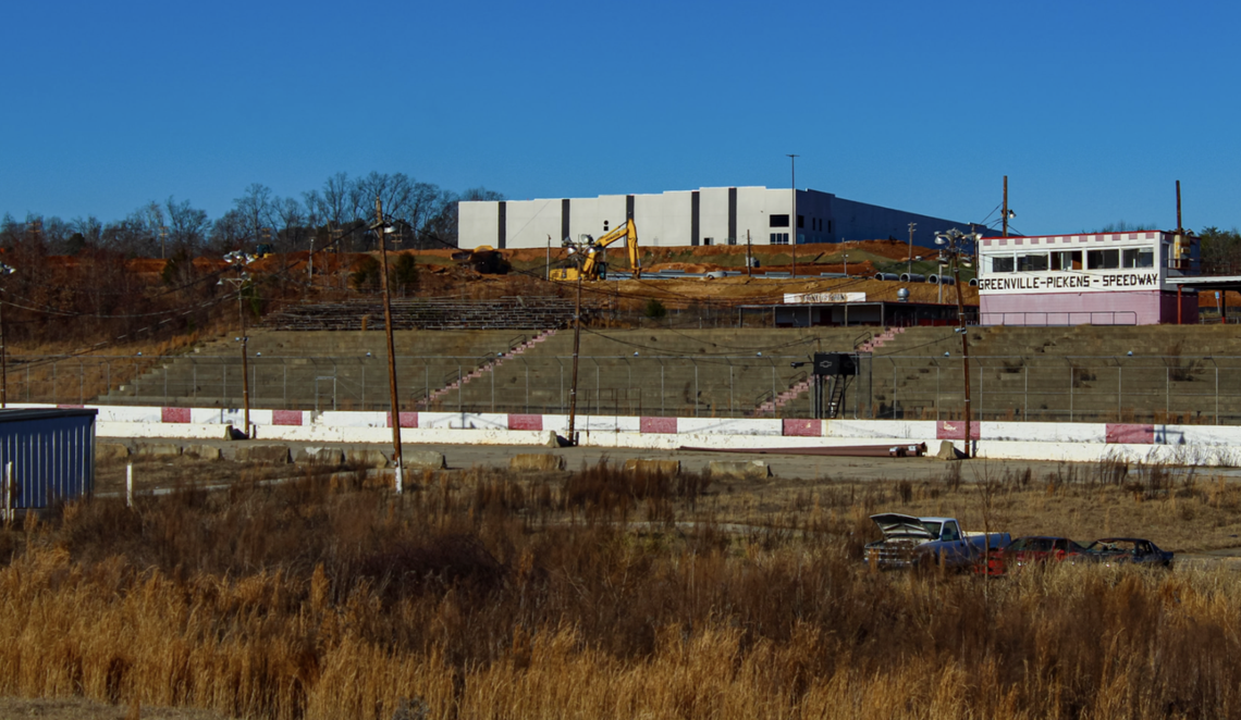 Portions of the Greenville Pickens Speedway are overgrown and junk cars have been abandoned in the infield.