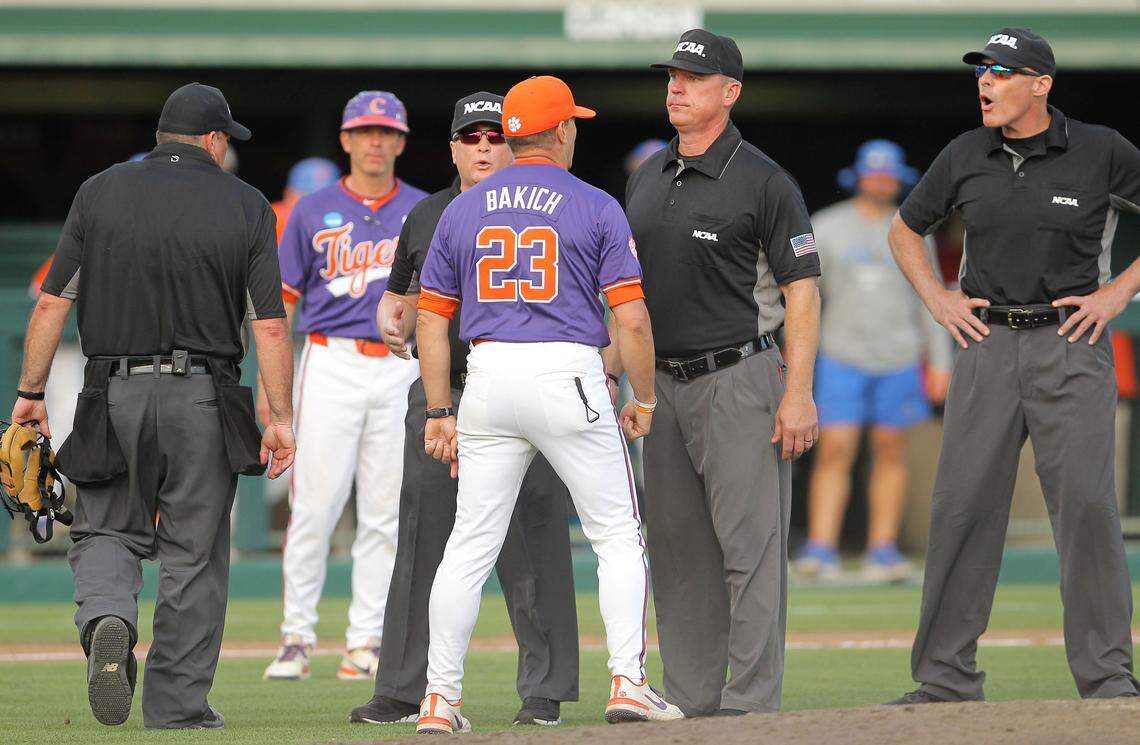 Clemson head coach Erik Bakich is walked back by umpires while trying to get a word in with Greg Harmon, at right, who ejected Bakich during NCAA Super Regionals action on Sunday, June 9, 2024 in Clemson, S.C.