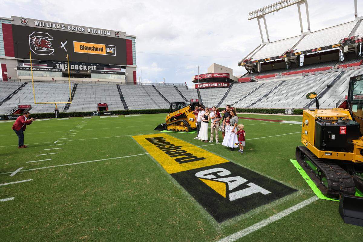 Members of the Blanchard family are seen on the field following a press conference announcing a partnership with Blanchard CAT at Williams-Brice Stadium in Columbia on Monday, August 11, 2025.