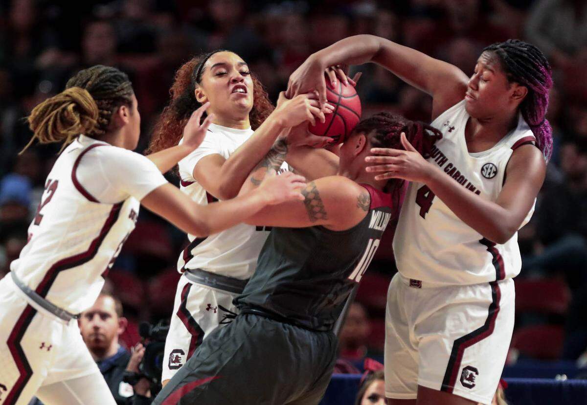 South Carolina’s Aliyah Boston (4) Brea Beal (12) and Tyasha Harris (52) pressure Arkansas’s Kiara Williams (10) during the first half of action during the SEC Tournament at the Bon Secours Wellness Arena in Greenville, S.C. 3/7/20