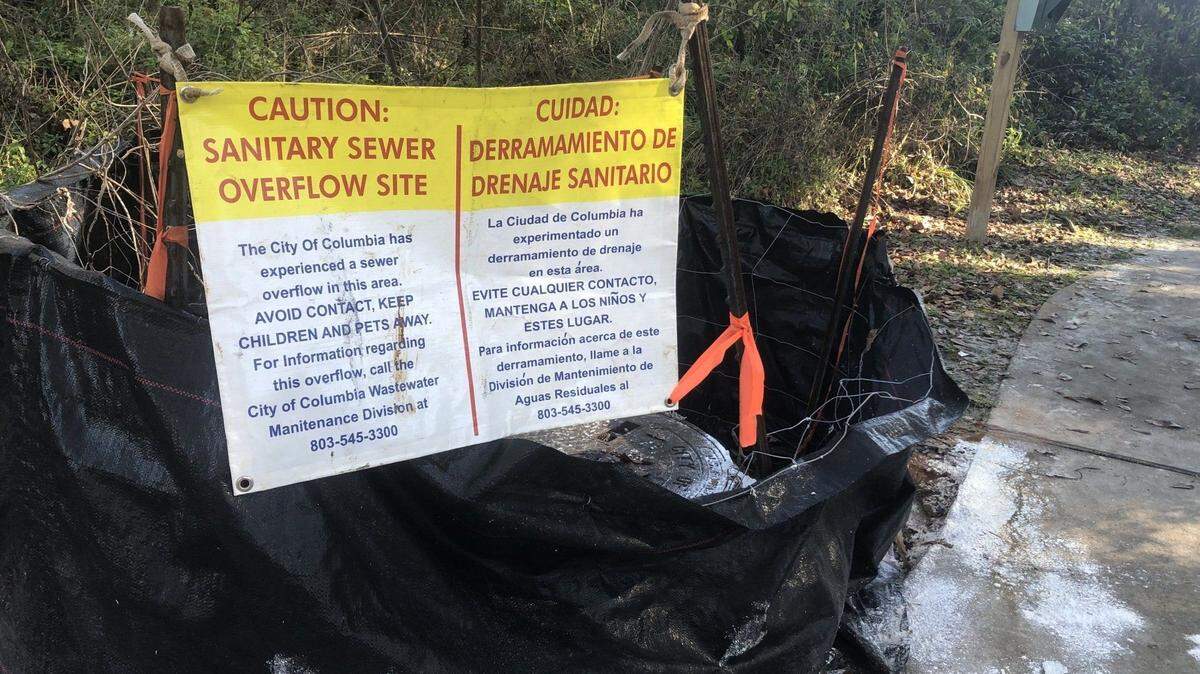 A sign warns of a sewer spill near the lower Saluda River.