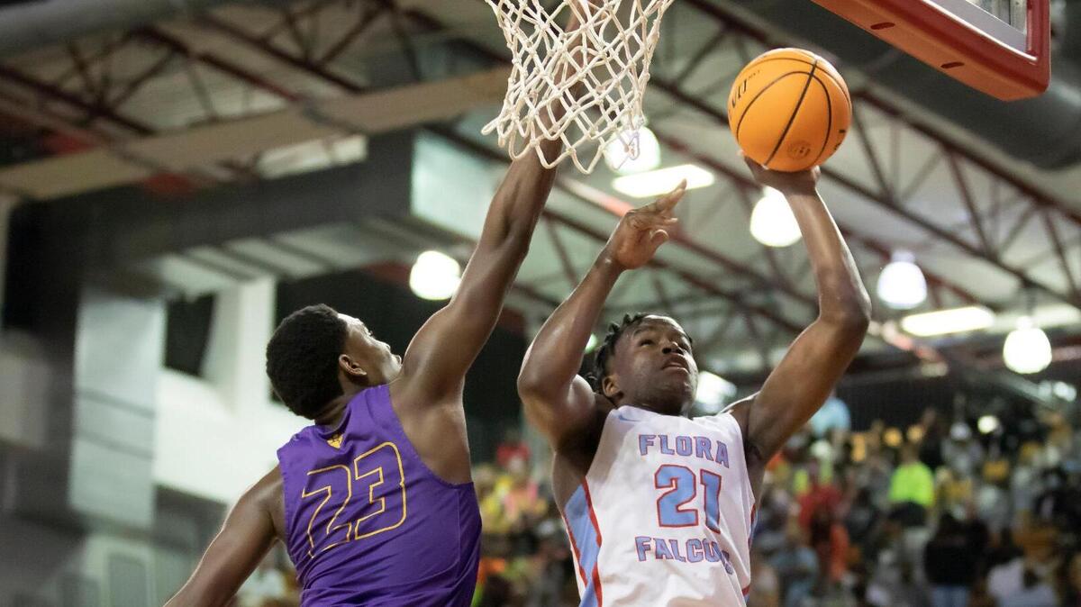 Christopher Parker of AC Flora High School puts up a shot as Josh Green of Wilson High School goes fore the block during the SCHSL Class 4A Boys Basketball State Championship at the USC Aiken Convocation Center on Saturday, March 5, 2022.
