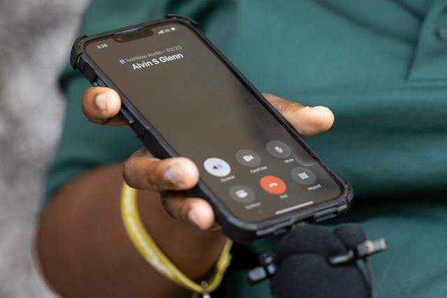 Tamara McGraw holds the phone while her husband, Joshua Steven McGraw, speaks during a press conference. The McGraws joined others who spoke about the conditions at Alvin S. Glenn Detention Center.