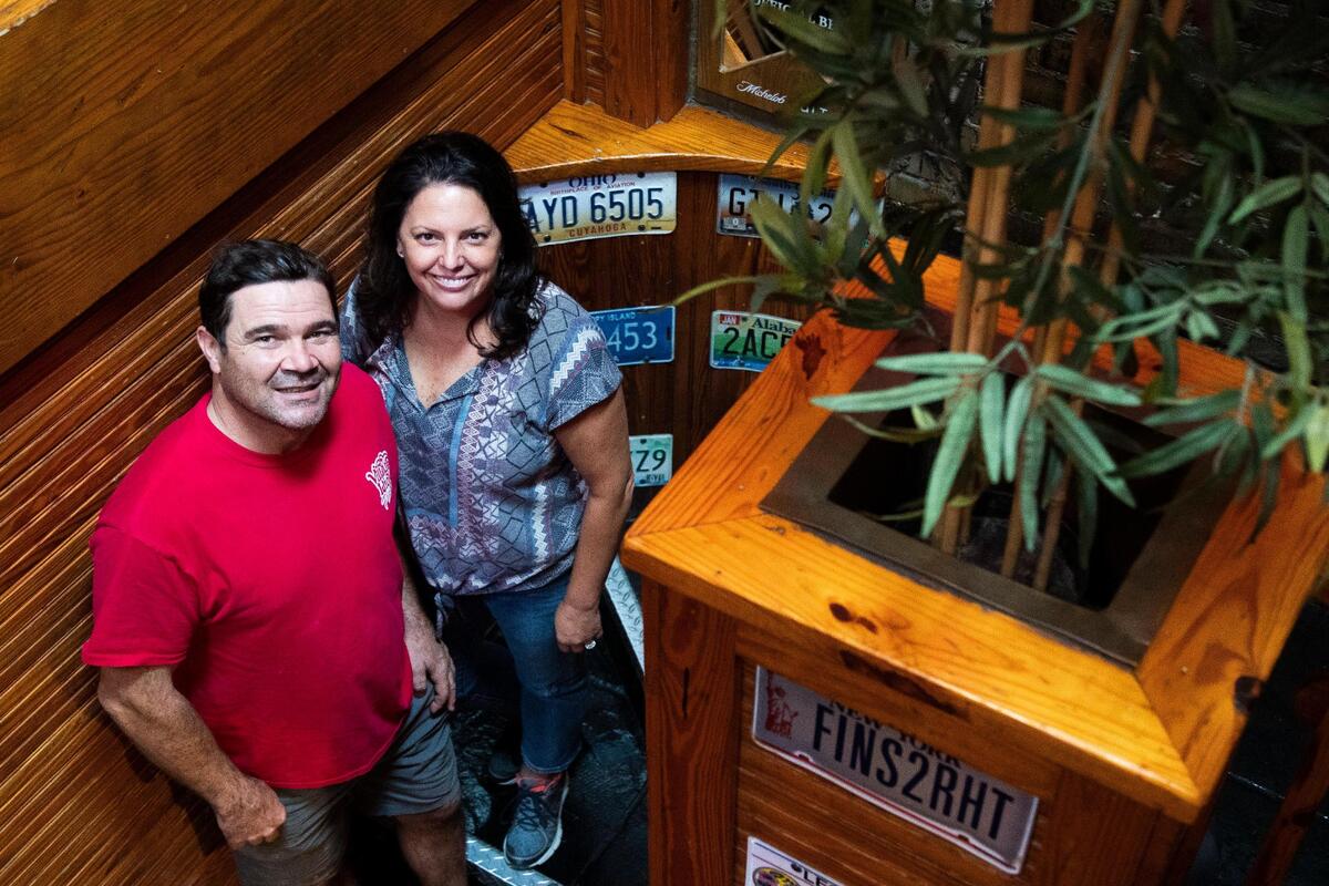 Brian and Kelly Glynn pose for a portrait at their restaurant on Tuesday, September 22, 2020. Village Idiot is celebrating 30 years of serving pizza in Five Points while also adapting to the coronavirus.