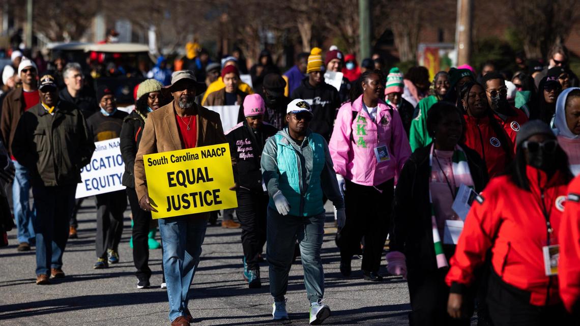People march to the South Carolina State House for King Day at the Dome, a Martin Luther King Day celebration hosted by the South Carolina NAACP, on Monday, January 16, 2023. Members of local and statewide civil rights organizations, religious and labor unions marched from Zion Baptist Church to the state capitol for the celebration.