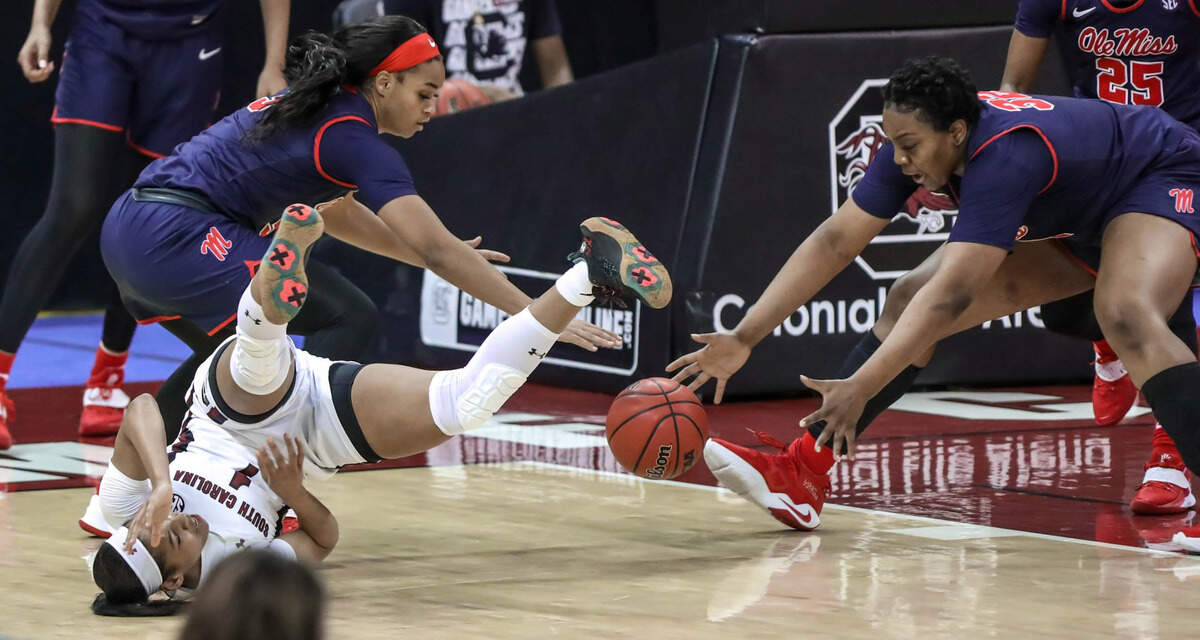 South Carolina Gamecocks guard Zia Cooke (1) falls as Ole Miss guard Donnetta Johnson (3) and forward Iyanla Kitchens (32) go for a loose ball during the first half of action in the Colonial Life Arena in Columbia, S.C.