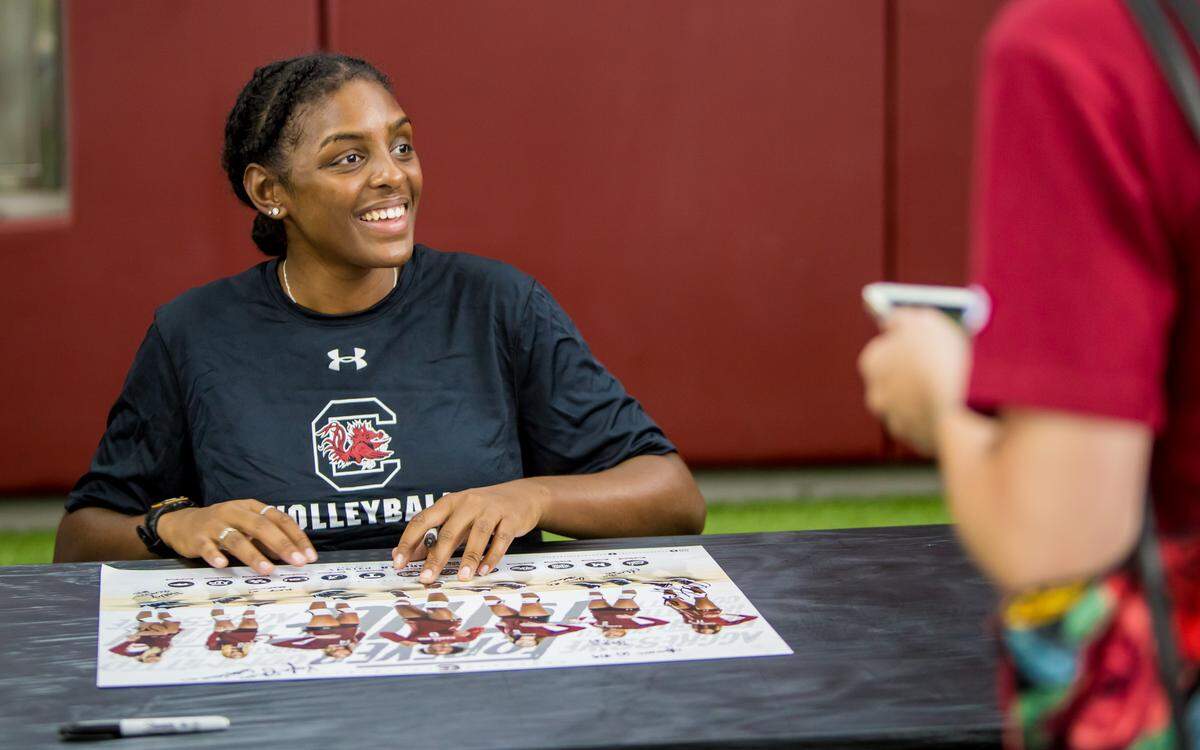 USC volleyball player Mikayla Shields signs an autograph during USC Fan Day. The volleyball team has made back-to-back NCAA tournaments and advanced past the first round each season.
