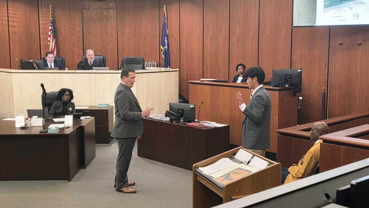 Andy Chow demonstrates before attorney Luke Shealey how Cyrus Carmack-Belton allegedly pointed a gun at him, during an incident on May 28, 2023, on Nov. 3, 2025, during an immunity hearing for Rick Chow.