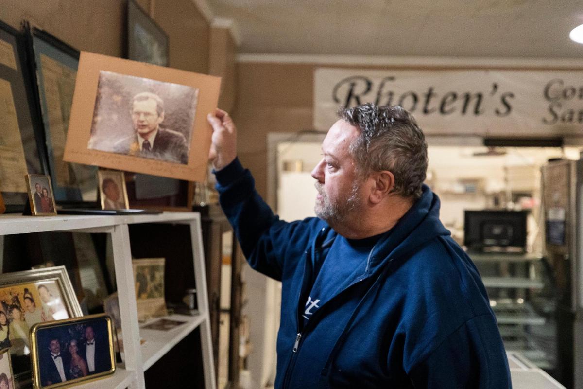 Wes Rhoten shows a photo of former South Carolina governor Richard Riley, who says the sausages at Rhoten’s Country Store are the best in the state. Rhoten and and his family have run the store since the 1940s.