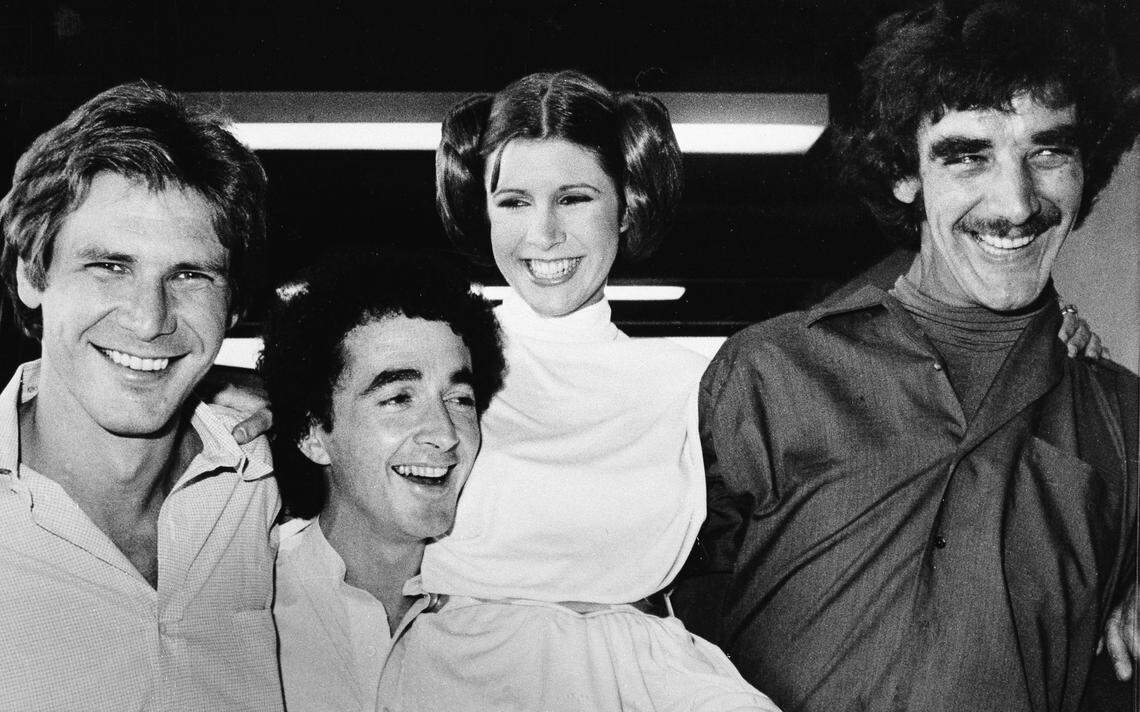 FILE - In this Oct. 5, 1978 file photo, actors featured in the “Star Wars” movie, from left, Harrison Ford who played Han Solo, Anthony Daniels who played the robot C3P0, Carrie Fisher who played the princess, and Peter Mayhew who played the Wookie, Chewbacca, are shown during a break from the filming of a television special presentation in Los Angeles. Mayhew, who played the rugged, beloved and furry Wookiee Chewbacca in the “Star Wars” films, has died. Mayhew’s family said in a statement that he died at his home in Texas on April 30. He was 74. No cause was given. (AP Photo, File)