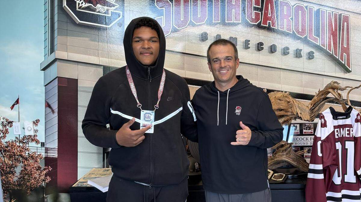 Four-star 2027 defensive lineman John Archer of Seventy-First (NC) High School with South Carolina football coach Shane Beamer