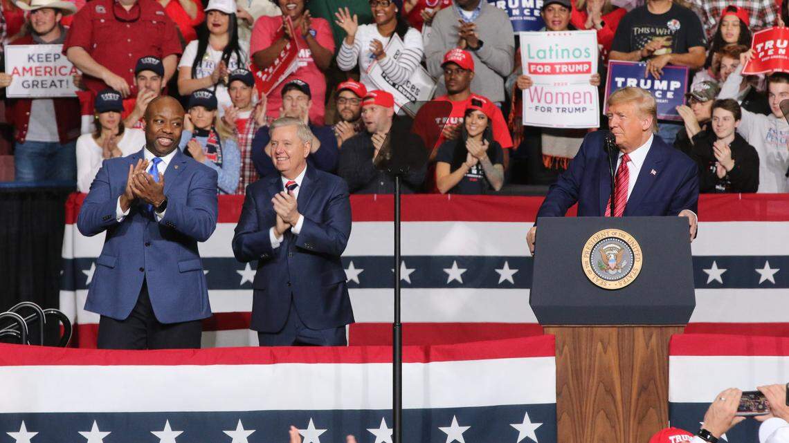 U.S. Sens. Tim Scott (left) and Lindsey Graham, both of South Carolina, with President Donald Trump at a rally in North Charleston on Feb. 28, 2020, the eve of the S.C. Democratic presidential primary.