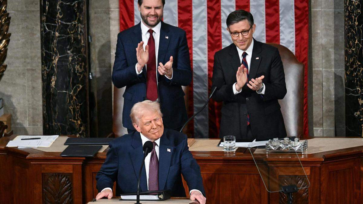 Vice President JD Vance, top left, and Speaker of the House Mike Johnson applaud as President Donald Trump arrives to address to a joint session of Congress in the House Chamber of the U.S. Capitol in Washington, D.C., on Tuesday, March 4, 2025. (Jim Watson/AFP/Getty Images/TNS)