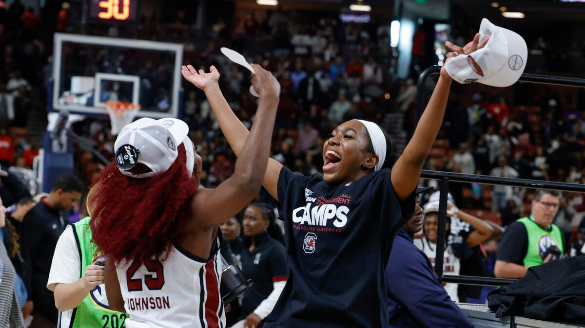 South Carolina’s Raven Johnson (25) celebrates with the SEC Tournament trophy after the Gamecocks beat LSU at Bon Secours Wellness Arena in Greenville on Sunday, Mar. 10, 2024.
