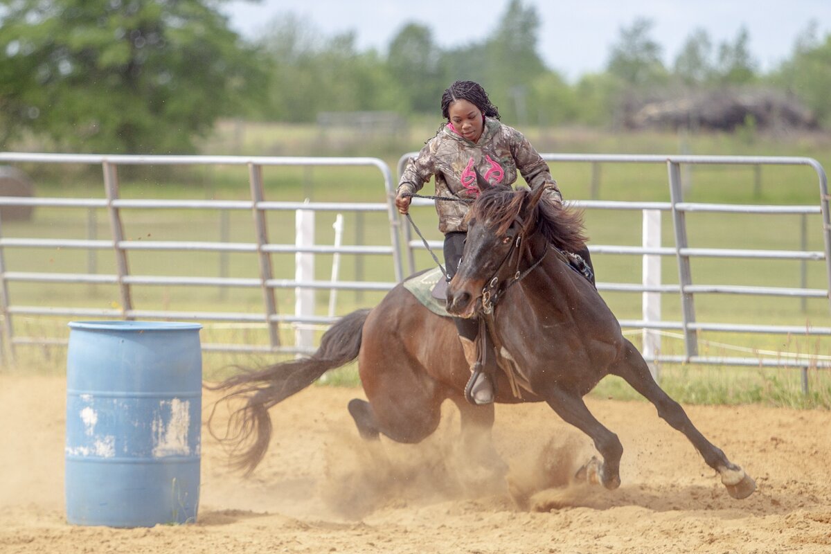 Zyarriah Myers, 16, goes through a barrel racing routine with her horse Coco, a 10-year-old Quarter Horse, on her grandparents ranch in Rembert, SC. Myers will be participating in rodeo events during the Black Cowboy “Man or Myth” African-American Cultural Festival.