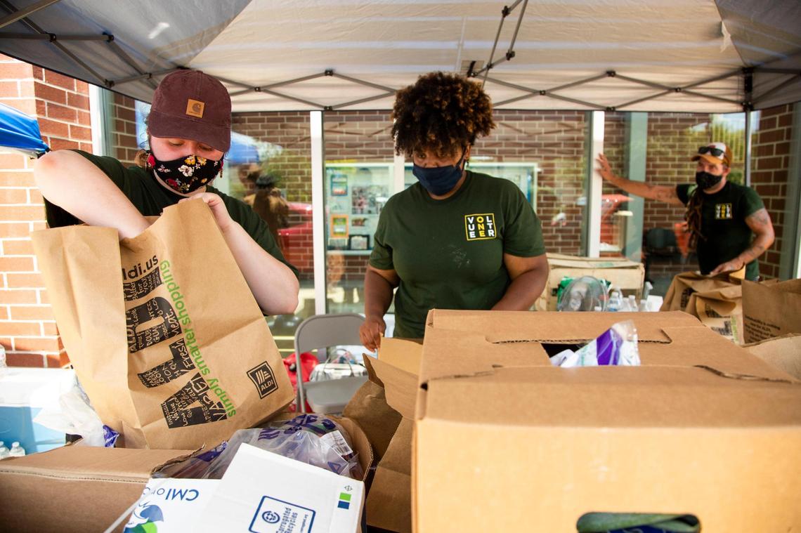 Volunteers with the Harden Food Initiative, a program organized by Empower SC in partnership with other food and justice organizations in Columbia, hand out food at the Drew Wellness Center on Friday, July31, 2020. Empower SC wanted to feed families in the neighborhood near the closed Save-a-Lot grocery store on Harden Street, and bring attention to the needs going unmet in the neighborhood.