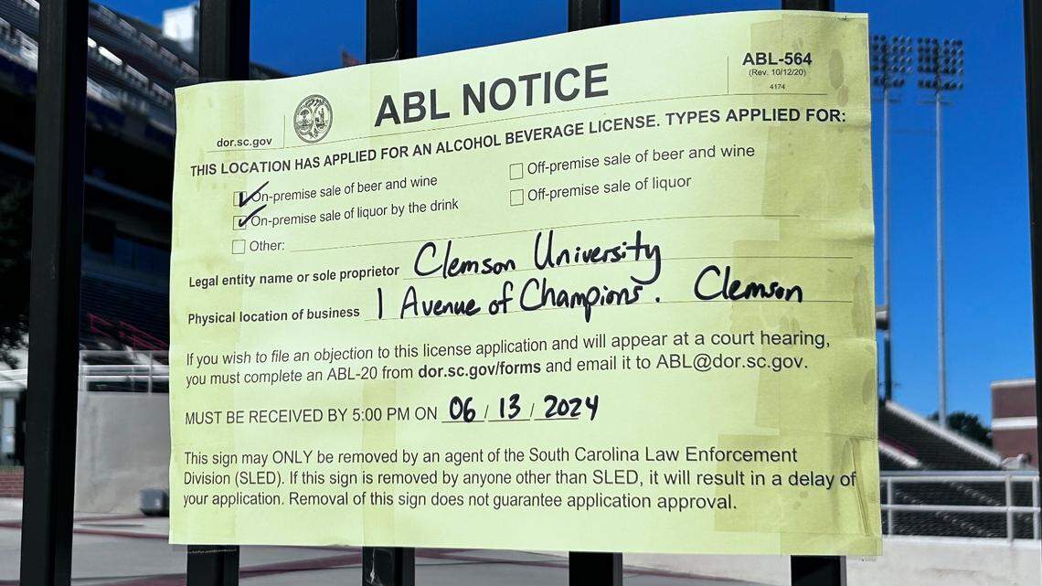 A notice of an application for an alcoholic beverage license posted on a gate outside Memorial Stadium, Clemson’s football stadium, on Thursday, May 30, 2024 on campus
