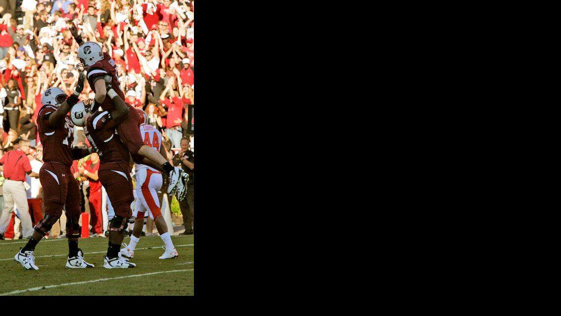 University of South Carolina QB #5 Stephen Garcia is hoisted into the air after delivering the final touchdown pass against Clemson University in the second half at Williams-Brice Stadium on Saturday. South Carolina won 34-17.