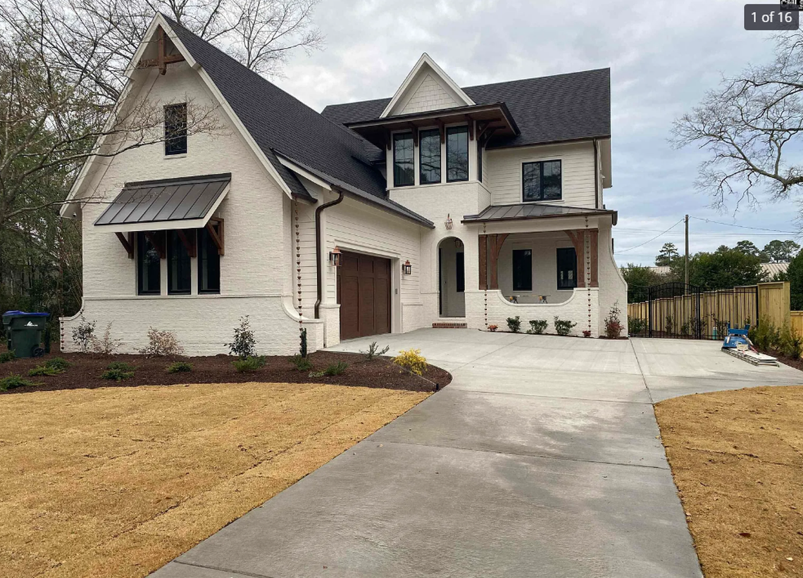 A screened porch with a fireplace and multi-slide doors that disappear into the wall is one of the standout features included in a $2.3 million, 5-bedroom new-construction home for sale in Forest Acres.