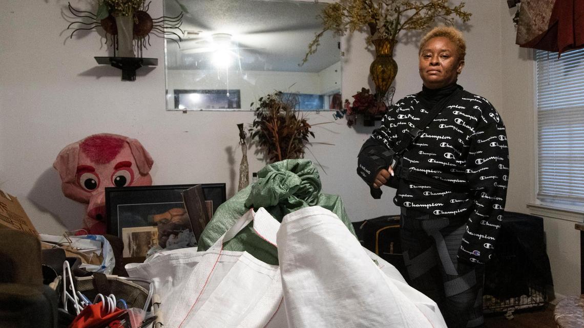 Lisa Belton has her arm in a sling while packing up her home on Thursday, October 28, 2021.