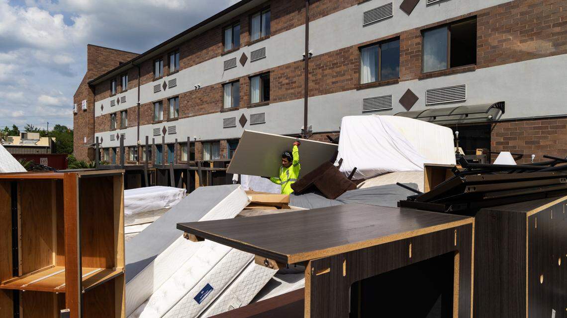 Workers take out old furniture from the Suburban Studios on Bush River Road on Wednesday, April 30, 2025. Homeless No More, a local nonprofit, is working with Lexington County to re-purpose the property with 31 housing units for people transitioning out of homelessness.