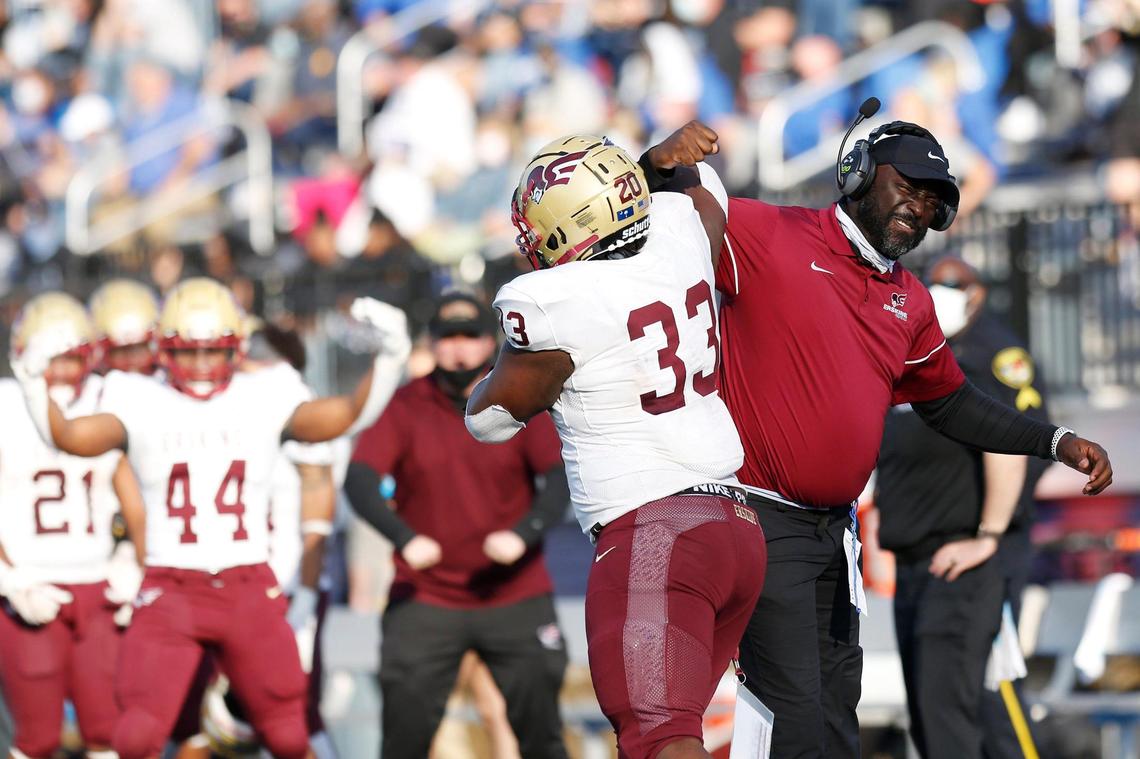 Erskine running back Rashad Luckey (33) celebrates with a coach after his touchdown in the fourth quarter of the game against Barton on Saturday.