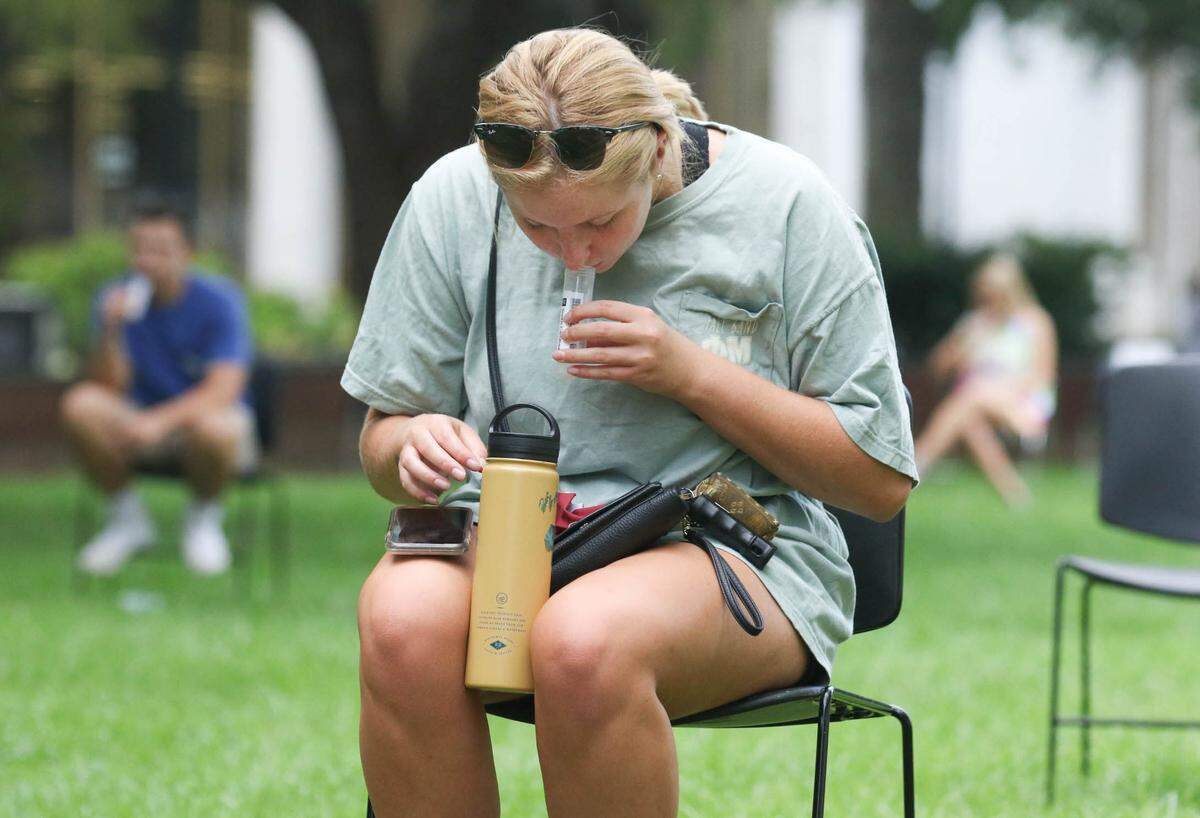 USC student Anne Mlodzinski spits into a collection vial for a saliva based COVID-19 test being administered on campus. The University of South Carolina is encouraging weekly tests to help control the spread of the coronavirus. Results from the test take less than 24 hours. 8/19/20