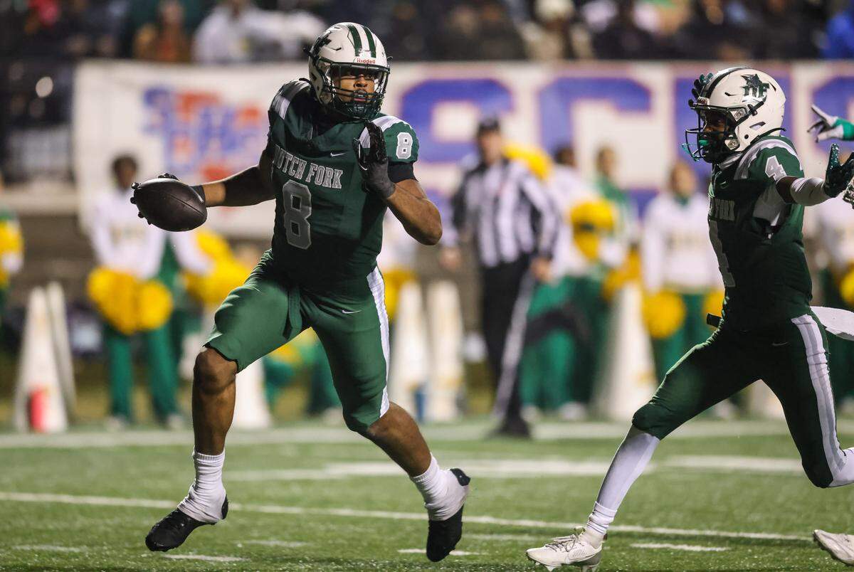 Julian Walker (8) of Dutch Fork picks up a fumble and runs it back for a touchdown during the SCHSL Class 5A Division I championship game between Dutch Fork and Summerville at Oliver C. Dawson Stadium in Orangeburg on Saturday.