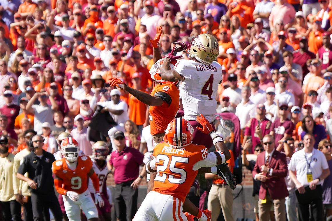 Sep 23, 2023; Clemson, South Carolina, USA; Florida State Seminoles wide receiver Keon Coleman (4) is defended by Clemson Tigers safety Jalyn Phillips (25) and cornerback Nate Wiggins (2) in the second half at Memorial Stadium. Mandatory Credit: David Yeazell-USA TODAY Sports