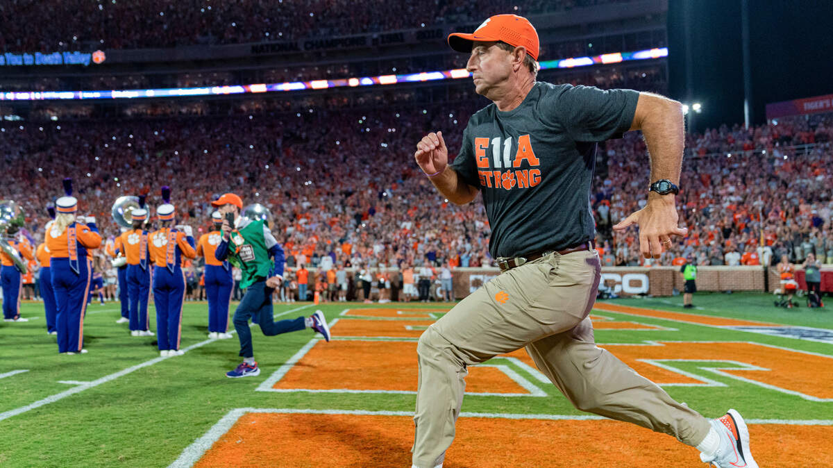 Clemson coach Dabo Swinney runs onto the field at the start of the team’s NCAA college football game against Louisiana Tech on Saturday, Sept. 17, 2022, in Clemson, S.C. (AP Photo/Jacob Kupferman)