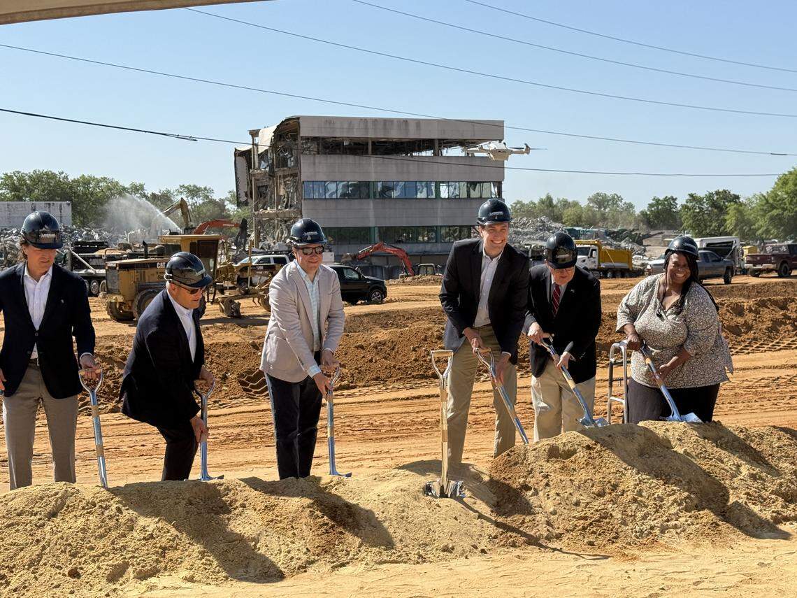 Happy smiles on a sad day. Officials from Landmark Properties and their law firm, Maynard Nexsen symbolically break ground for their new student apartment development on Shop Road. At right is Richland County councilwoman Cheryl English, who helped change the property’s zoning. 