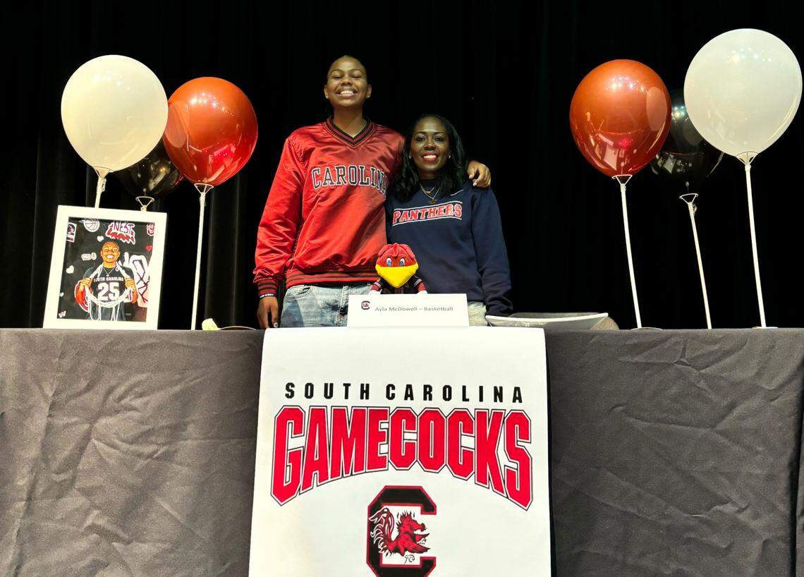 Ayla McDowell at her signing day ceremony with Cypress Springs basketball coach Taneisha Rogers