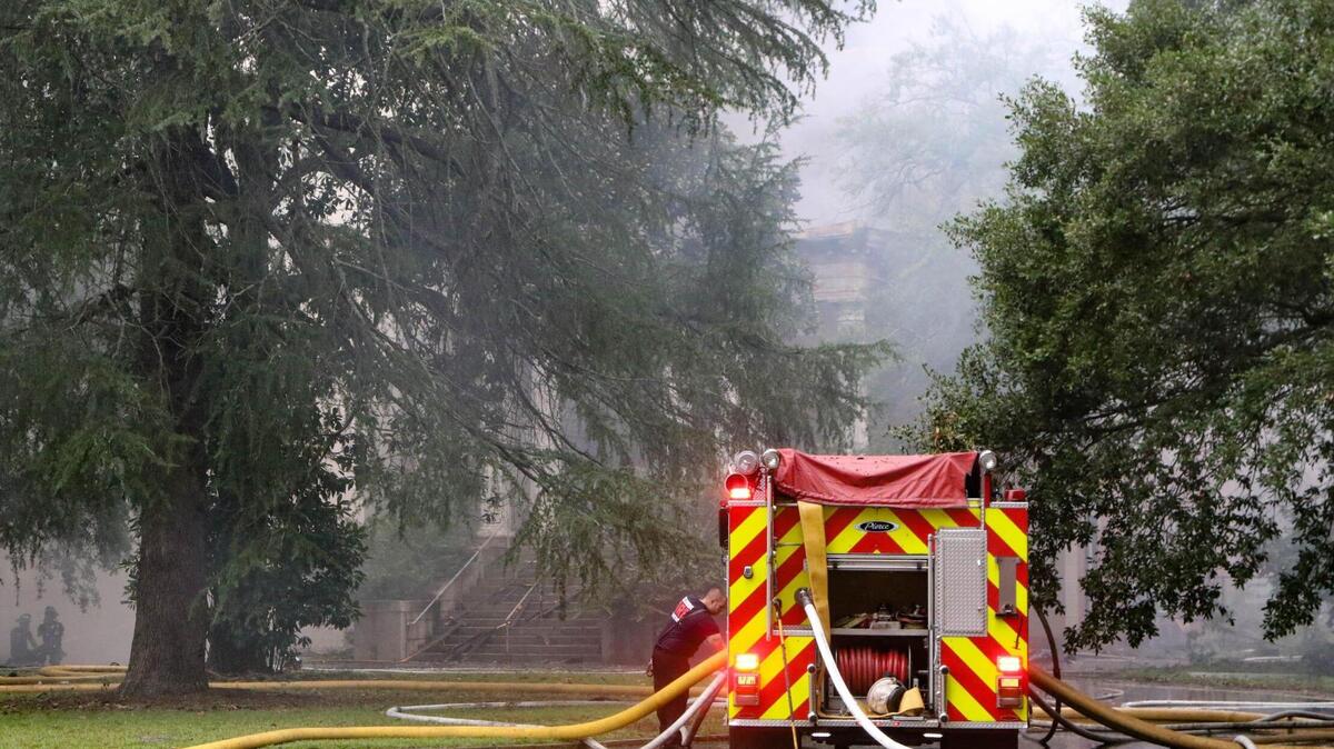Firefighters work to extinguish a massive fire in the historic Babcock building on the BullStreet Campus.