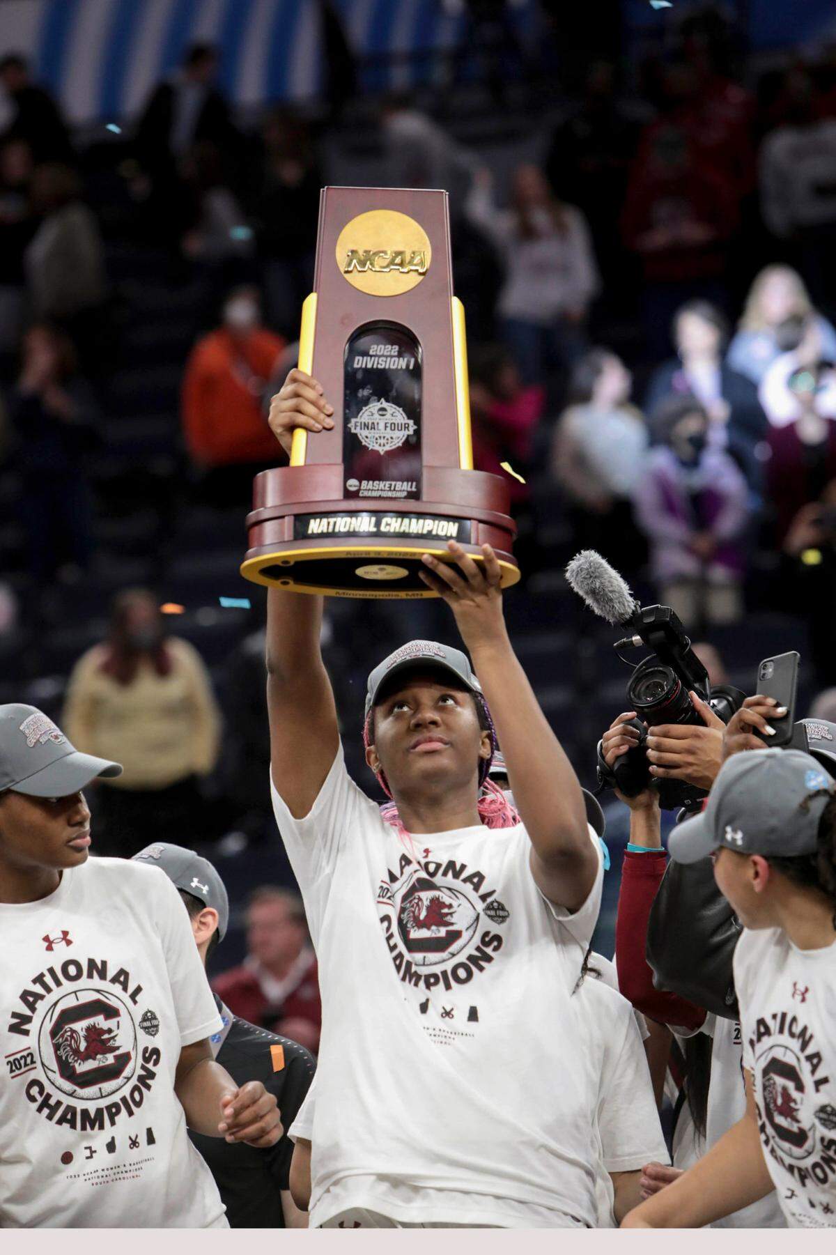 South Carolina’s Aliyah Boston (4) holds up the national championship trophy after winning the national championship game against UConn at the Target Center in Minneapolis, Minn. on Sunday April 3, 2022.