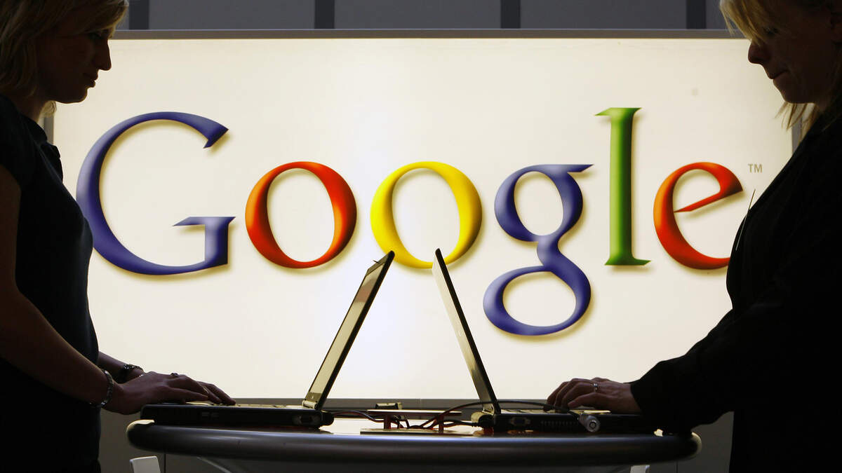 This file photo shows people working in front of an illuminated Google sign, and a new study revealed the most popular medical symptoms looked up on the search engine.